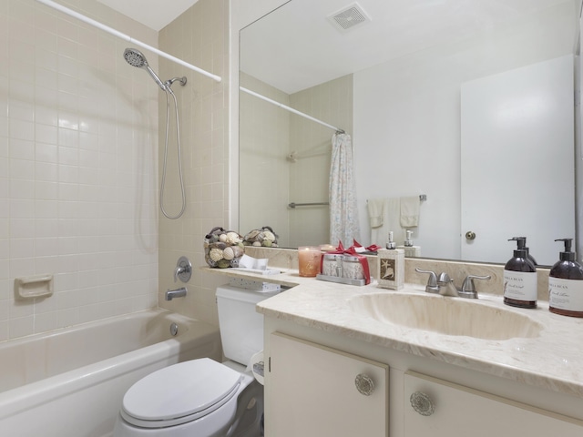 bathroom featuring toilet, vanity, and shower / washtub combination