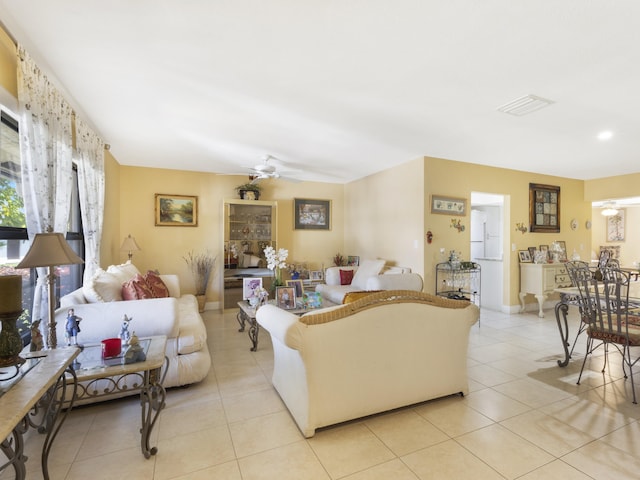 living room with a ceiling fan and light tile patterned floors