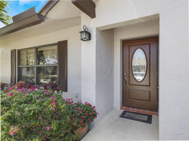 entrance to property with stucco siding