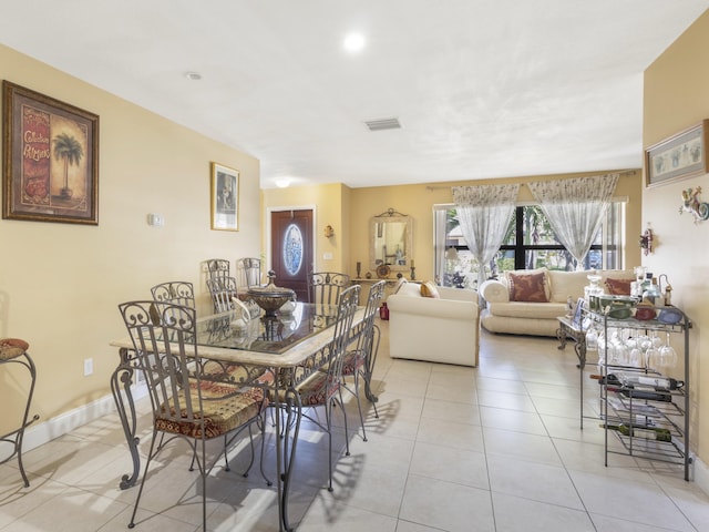 dining space featuring light tile patterned flooring, baseboards, and recessed lighting