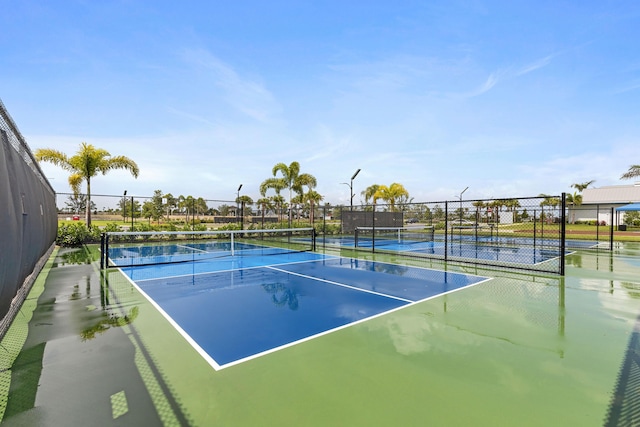 view of tennis court featuring fence