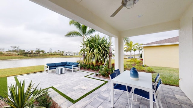 view of patio with a water view, a ceiling fan, an outdoor hangout area, and outdoor dining space