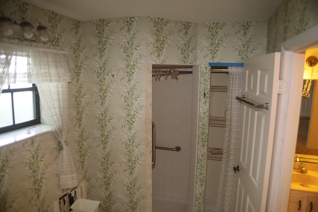 full bath featuring a stall shower and a sink