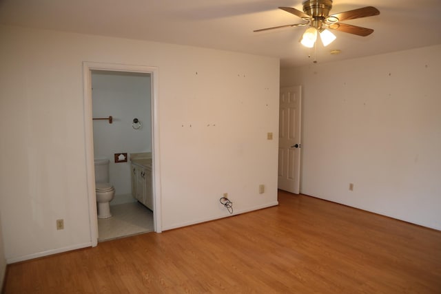 unfurnished bedroom featuring light wood-style floors and ensuite bath