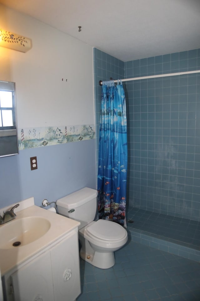 bathroom featuring tile patterned floors, tiled shower, toilet, and vanity