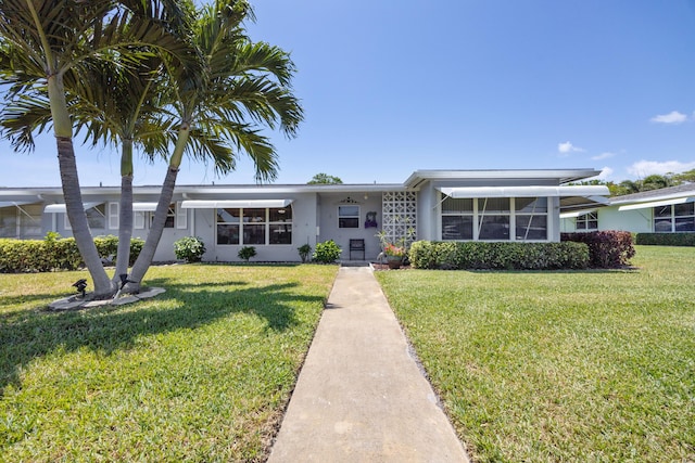 ranch-style house featuring stucco siding and a front lawn
