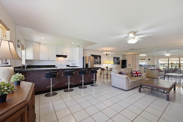 living room featuring ceiling fan and light tile patterned flooring