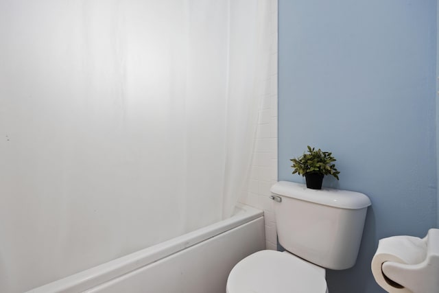 full bath with toilet and shower / tub combo with curtain