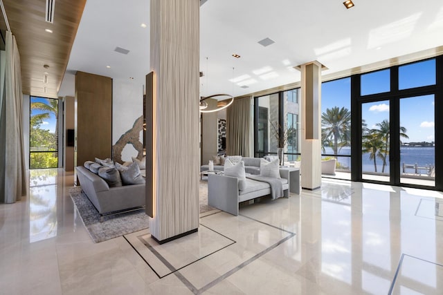 lobby with floor to ceiling windows and a water view