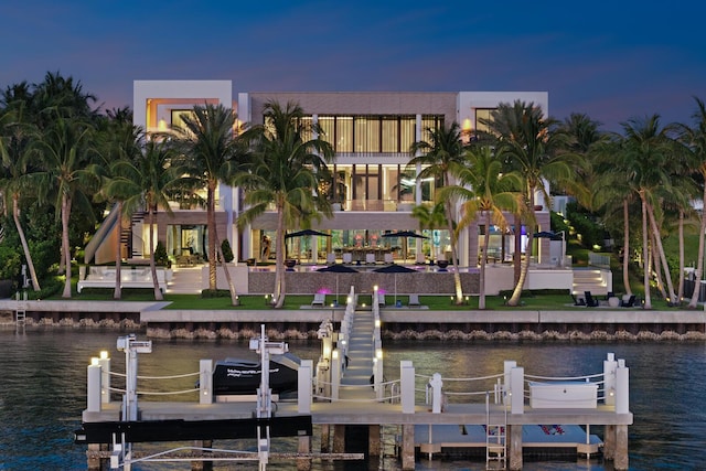 dock area featuring boat lift and a water view