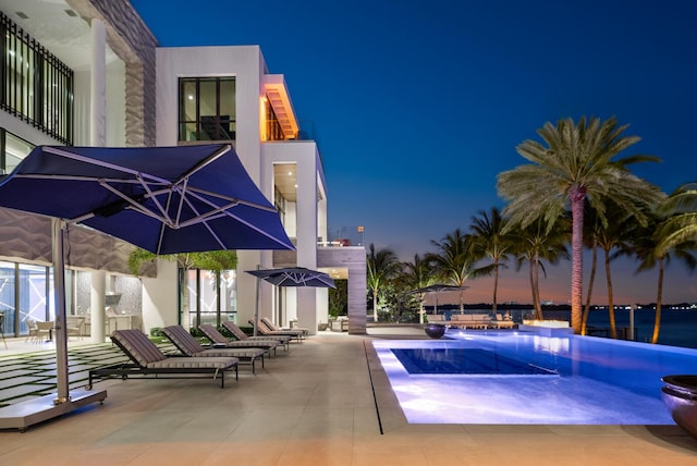 view of pool with an infinity pool and a patio