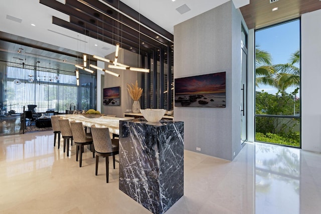dining room featuring a chandelier, plenty of natural light, a high ceiling, and tile patterned floors