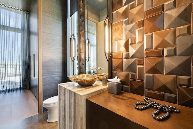 bathroom with toilet, tile patterned floors, and vanity
