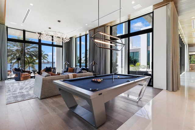 1940 S Ocean Blvd, Manalapan, FL 33462 - recreation room featuring a wall of windows, a chandelier, billiards table, a towering ceiling, and wood finished floors