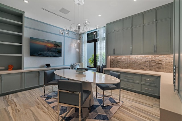 dining space featuring built in features and a chandelier