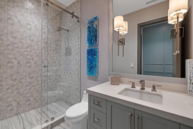 bathroom featuring a stall shower, toilet, and vanity