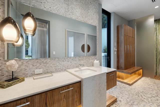 bathroom featuring decorative backsplash and vanity