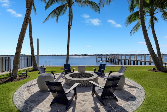 view of patio with an outdoor fire pit and a water view