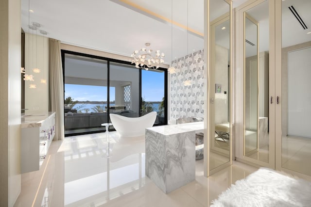 full bathroom featuring tile patterned floors, a chandelier, and a freestanding bath
