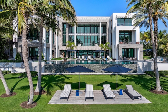 view of pool featuring a lawn