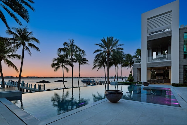 view of swimming pool with a water view and an infinity pool