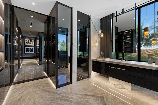 bathroom with marble tiled flooring and vanity