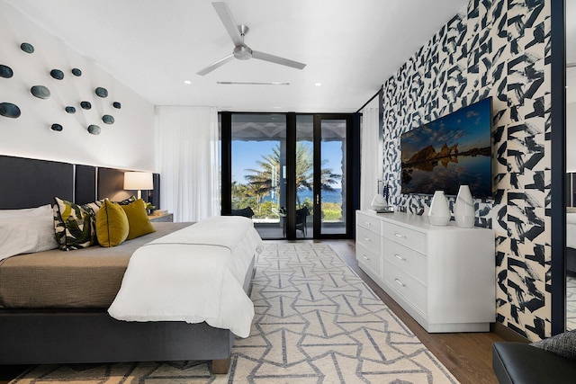 bedroom with access to outside, expansive windows, wood finished floors, ceiling fan, and recessed lighting
