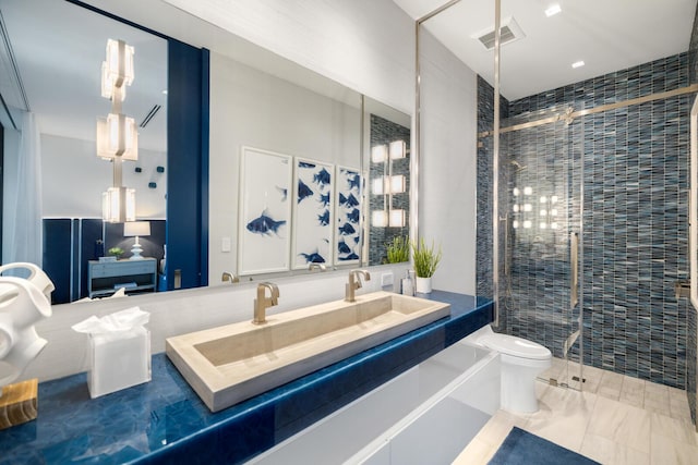 bathroom featuring toilet, a shower stall, and vanity