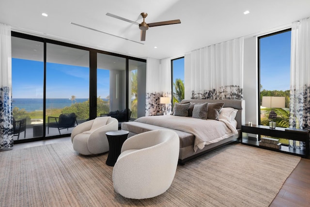 1940 S Ocean Blvd, Manalapan, FL 33462 - bedroom with expansive windows, wood finished floors, ceiling fan, a water view, and access to exterior