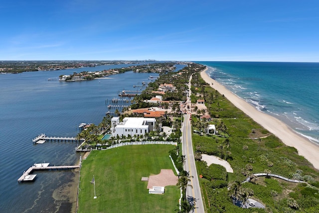 aerial view of property's location featuring waterfront with a beach