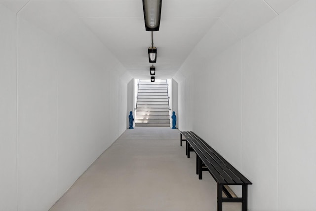 hallway with stairs and finished concrete flooring