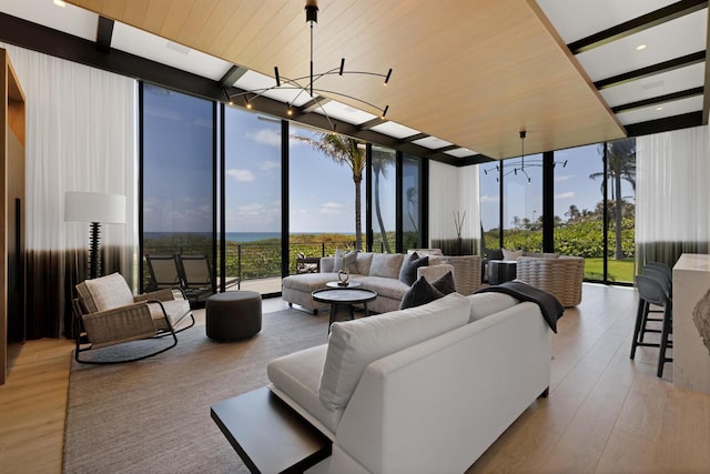 sunroom / solarium featuring a chandelier and beam ceiling