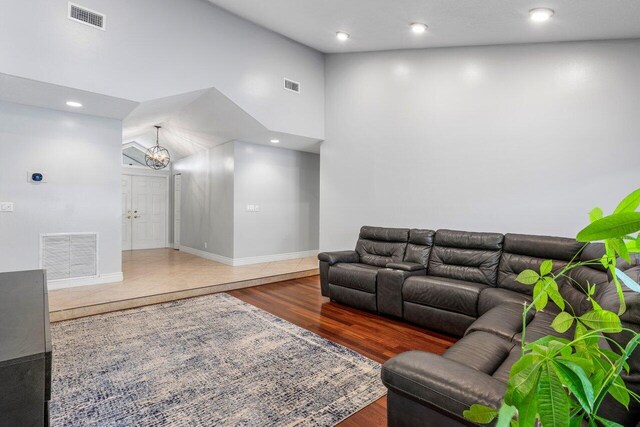 18320 181st Cir S, Boca Raton, FL 33498 - living room featuring a chandelier, wood finished floors, high vaulted ceiling, recessed lighting, and baseboards