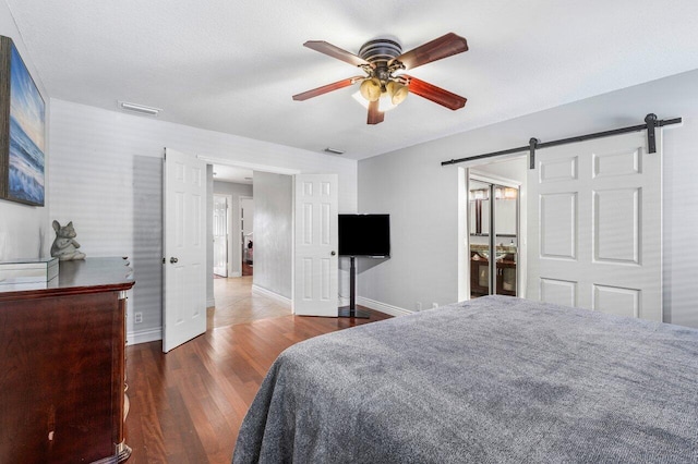 18320 181st Cir S, Boca Raton, FL 33498 - bedroom with a barn door, baseboards, wood finished floors, and ceiling fan