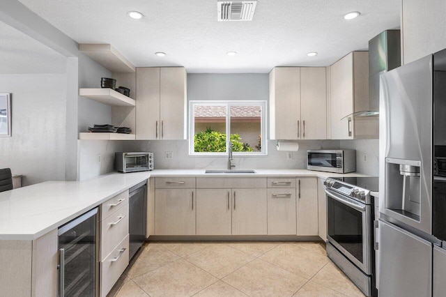18320 181st Cir S, Boca Raton, FL 33498 - kitchen with appliances with stainless steel finishes, beverage cooler, a sink, a peninsula, and open shelves