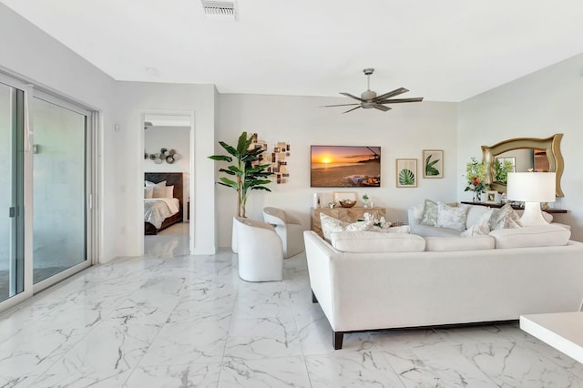 living room featuring ceiling fan and marble finish flooring