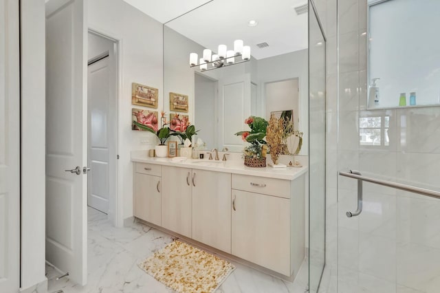 bathroom featuring a stall shower, a chandelier, vanity, and marble finish flooring