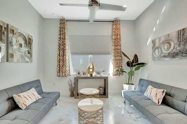 living room featuring marble tiled floors and ceiling fan