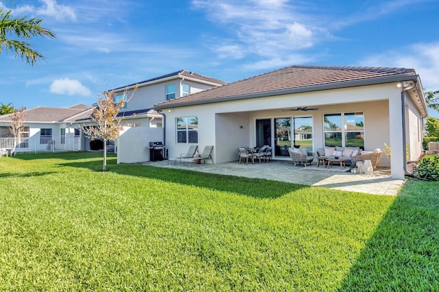 back of property featuring outdoor lounge area, a ceiling fan, stucco siding, and a tiled roof