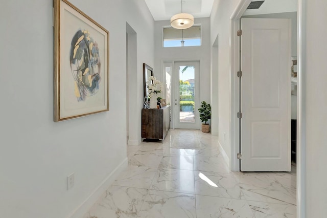 entryway featuring baseboards and marble finish flooring