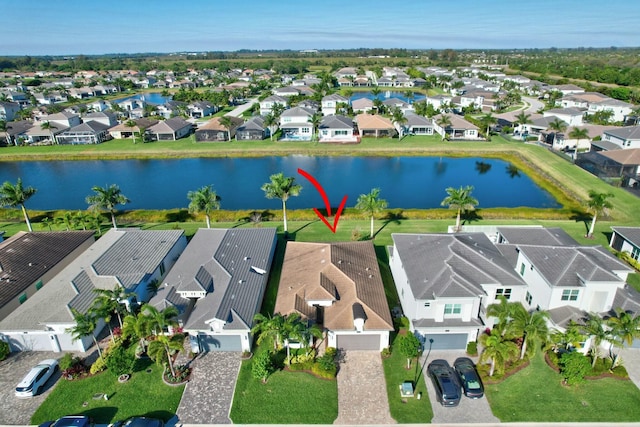 aerial view of residential area featuring a large body of water