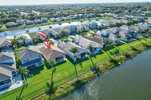 aerial view of residential area with a large body of water