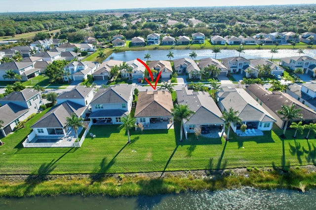 aerial perspective of suburban area with a nearby body of water