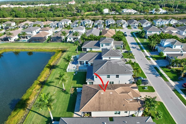 aerial view of property and surrounding area with nearby suburban area and a large body of water