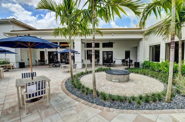 view of patio / terrace featuring a fire pit, french doors, and outdoor dining space