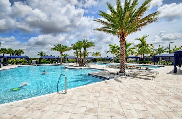 community pool with a patio area and a gazebo
