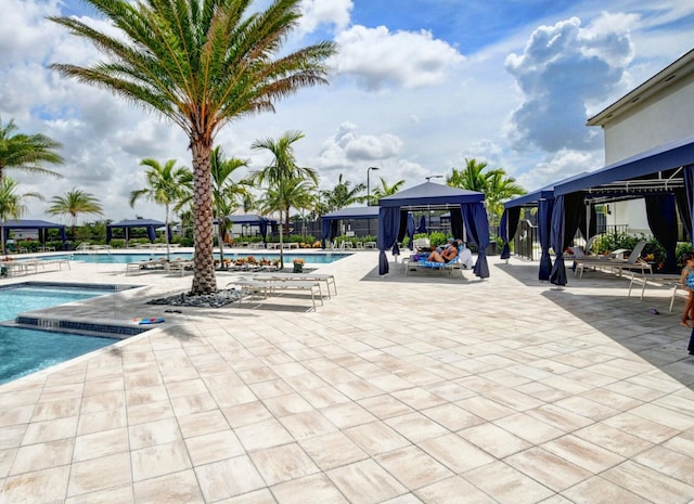 community pool featuring a gazebo and a patio area