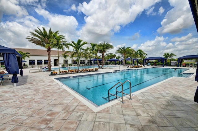 community pool featuring a gazebo and a patio area