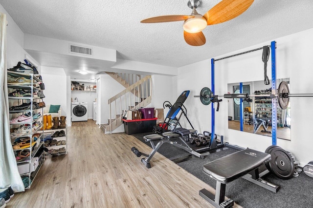 4059 Palm Bay Cir Unit C, West Palm Beach, FL 33406 - exercise room with wood finished floors, a textured ceiling, a ceiling fan, and washing machine and clothes dryer