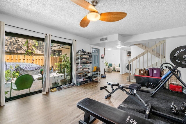 4059 Palm Bay Cir Unit C, West Palm Beach, FL 33406 - exercise room with ceiling fan, wood finished floors, and a textured ceiling